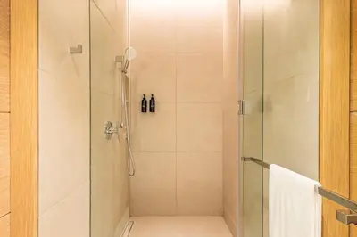 a bathroom with a shower with a glass door at High-Floor Luxury 2BR, Sea View, Address JBR in Dubai