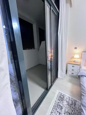 a bathroom with a glass shower with a mirror at Azizi riviera in Dubai
