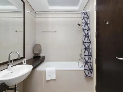 a bathroom with a sink and a bath tub at Dream Palm Residence 3BR Luxury Apartment on Palm Jumeirah in Dubai