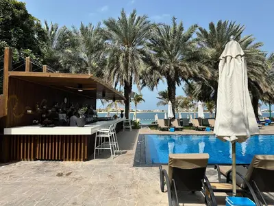 a resort with a pool and a bar next to a resort at Dream Palm Residence 3BR Luxury Apartment on Palm Jumeirah in Dubai