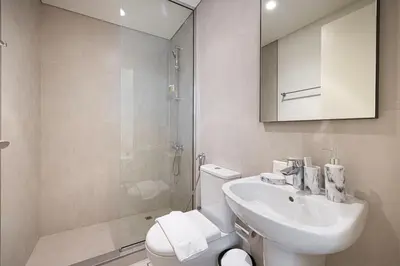 a bathroom with a toilet and a sink and a shower at Luxury 4BR Villa, Bali Pool Retreat, Ruba A Ranches 3 in Dubai
