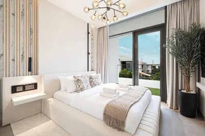 a white bedroom with a white couch and a large window at Luxury 4BR Villa, Bali Pool Retreat, Ruba A Ranches 3 in Dubai