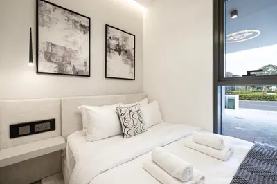 a white room with a couch and a window at Luxury 4BR Villa, Bali Pool Retreat, Ruba A Ranches 3 in Dubai