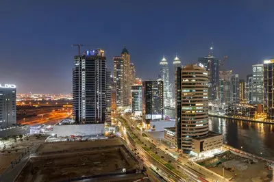 a view of a city at night with buildings at FIRST CLASS Studio Cozy Luxe Sanctuary in Dubai