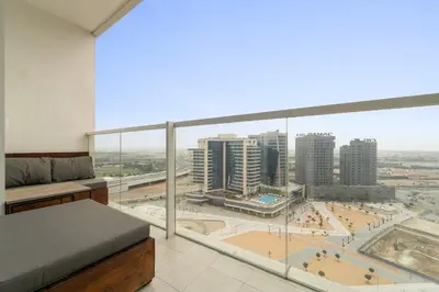 a bedroom with a large window with a view of a city at FIRST CLASS Studio Cozy Luxe Sanctuary in Dubai
