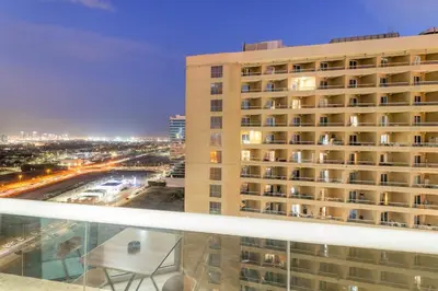 a hotel balcony with a view of a city at FIRST CLASS Studio Cozy & Chic Retreat in Dubai