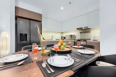 a kitchen with a table with plates and glasses of juice at Spacious Dubai Apartment with Water Views and Luxury Amenities in Dubai