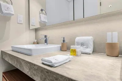 a bathroom counter with a sink and towels on it at Spacious Dubai Apartment with Water Views and Luxury Amenities in Dubai