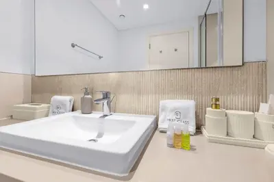 a bathroom with a white sink and a mirror at Spacious Dubai Apartment with Water Views and Luxury Amenities in Dubai