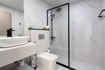 a bathroom with a shower and a toilet and a sink at Dubai Marina - 1 BHK Stunning Apartment in Dubai