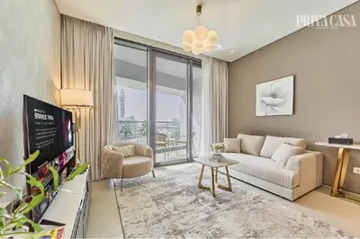 a living room with a couch and a tv at PRIVACASA - The Address Beach Resort residences in Dubai
