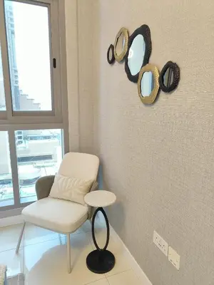 a room with a chair and mirrors on the wall at Marina Bliss Luxe Stay with Waterfront and Palm Views in Dubai