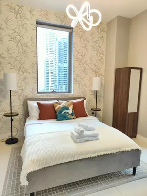 a bedroom with a bed with two towels on it at Marina Bliss Luxe Stay with Waterfront and Palm Views in Dubai