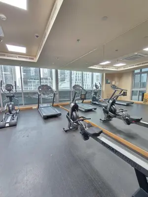 a gym with several treadmills and elliptical machines at Marina Bliss Luxe Stay with Waterfront and Palm Views in Dubai