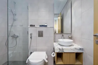 a bathroom with a sink and a toilet and a shower at Aykon City Panoramic Skyline View in Dubai