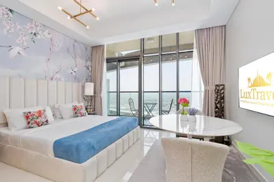 a bedroom with a large bed and a table at Aykon City Panoramic Skyline View in Dubai