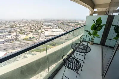two chairs on a balcony with a view of a city at Aykon City Panoramic Skyline View in Dubai