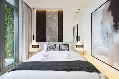 a bedroom with a large white bed and a large window at Elegant 4BR Villa, Bali Pool Retreat, Ruba, A Ranches 3 in Dubai