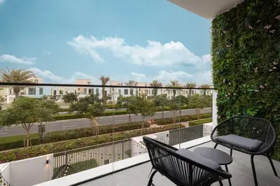 a balcony with two chairs and a view of a street at Elegant 4BR Villa, Bali Pool Retreat, Ruba, A Ranches 3 in Dubai