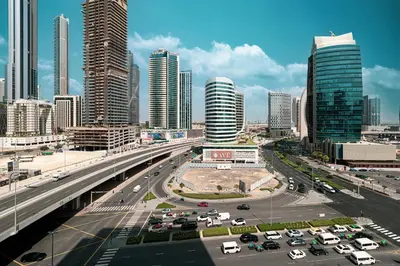 a highway in a city with cars and buildings at 2BR Dubai Gem steps from Dubai Mall & Burj in Dubai