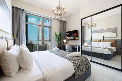 a bedroom with a large bed and a large window at 2BR Dubai Gem steps from Dubai Mall & Burj in Dubai