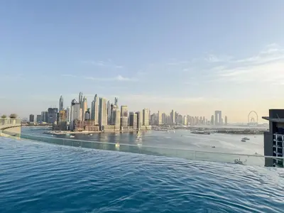 a view of the city from the infinity pool at The Seven Palm with free rooftop pool & beach in Dubai