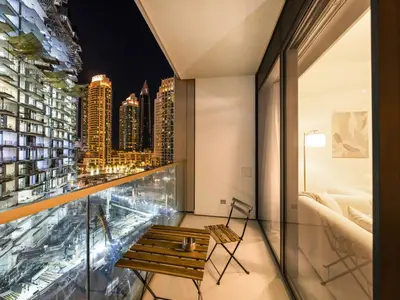 a balcony with a bench and a view of the city at EMAAR GRANDE 1BR Downtown I Steps to Fountain & Dubai Mall in Dubai