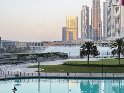a view of a city with a fountain in the background at EMAAR GRANDE 1BR Downtown I Steps to Fountain & Dubai Mall in Dubai
