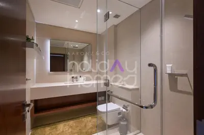 a bathroom with a shower and a toilet and a sink at Spacious and Elegant 2BR Marina Gate 2 in Dubai