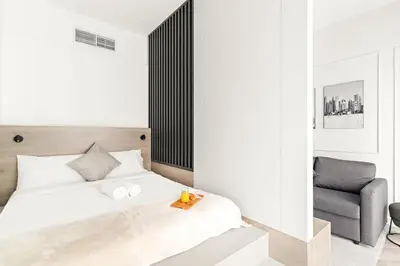 a bedroom with a bed and a chair at Central Downtown Studio by Burj Khalifa & Mall in Dubai