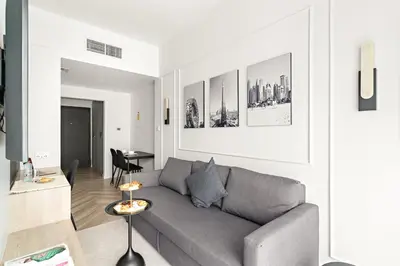 a living room with a couch and a table at Central Downtown Studio by Burj Khalifa & Mall in Dubai