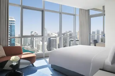 a bedroom with a white bed and a large window at InterContinental Dubai Marina by IHG in Dubai