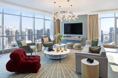 a living room with a couch and chairs and a tv at InterContinental Dubai Marina by IHG in Dubai