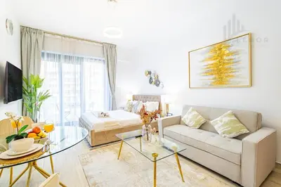 a living room with a couch and a table at Chic Studio Living JVC in Dubai