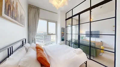 a bedroom with a bed and a large window at Cozy and Modern 1BR in Dubai Hills in Dubai