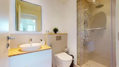 a bathroom with a sink and a toilet and a shower at Cozy and Modern 1BR in Dubai Hills in Dubai