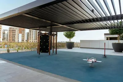 a playground with a skateboard under a canopy at Palace residence creek harbour in Dubai