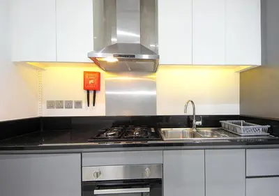 a kitchen with a sink and a stove at Modern Canal View with Balcony Damac Prive Dubai in Dubai