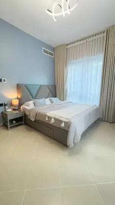 a bedroom with a large bed and a window at Metro Access,Insulated in Dubai