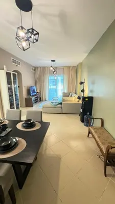 a living room with a table and a couch at Metro Access,Insulated in Dubai