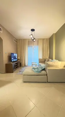 a living room with a couch and a flat screen tv at Metro Access,Insulated in Dubai