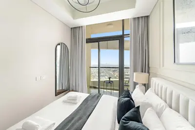 a bedroom with a large bed with a large window at Silkhaus Spacious 2BR in Aykon City Near Safa Park in Dubai