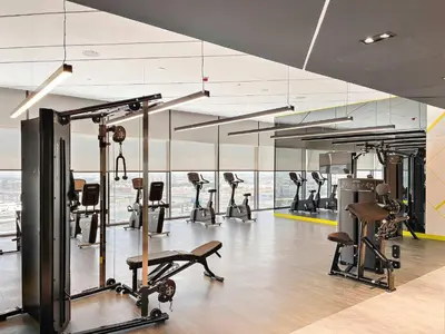 a gym with several treadmills and exercise bikes at Silkhaus Spacious 2BR in Aykon City Near Safa Park in Dubai