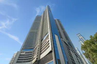 a tall building with a blue sky in the background at Silkhaus Spacious 2BR in Aykon City Near Safa Park in Dubai