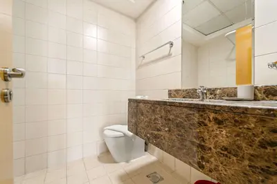 a bathroom with a sink and a toilet at Silkhaus Homey 2BR at Mayfair Tower in Business Bay in Dubai