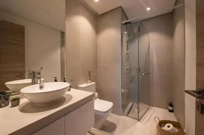 a bathroom with a shower and a sink and a toilet at The Designers Apartment Dubai Marina in Dubai