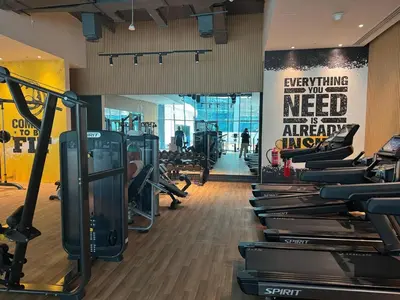 a gym with treadmills and a sign that says everything you need is amazing at Dubai Palm Jumeirah - Free Infiniti Pool and Private Beach in Dubai