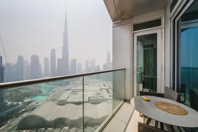 a balcony with a table and a view of a city at Address Dubai Mall Residences in Dubai