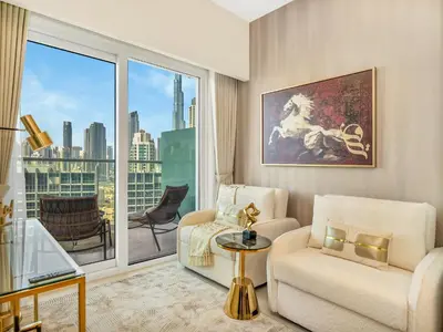 a living room with a couch and a large window at Burj Khalifa View Luxury Apt - 7 min to Dubai Mall in Dubai