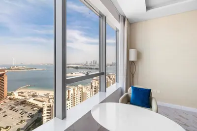 a room with a table and a view of the city at Sea View Apartment by St Regis 5 stars Infinity Pool in Dubai